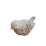 We are loving the embossed floral design on the one side of this distressed white bird that is looking down!

&nbsp;Polyresin, Stone Powder

Approximately 3" H x 2.5" W x 4.5" D
