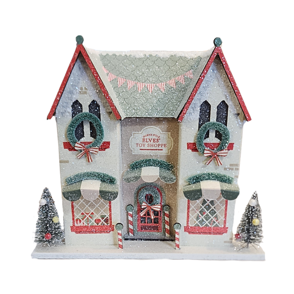 Create a festive party vibe with this Elves' Workshop Christmas village decor. This lively decoration brings the magic of Santa’s elves to life, setting the perfect scene for holiday fun and celebration. Add a playful touch to your seasonal gatherings and watch as your guests are enchanted by this charming winter wonderland centerpiece.

House is 6.5