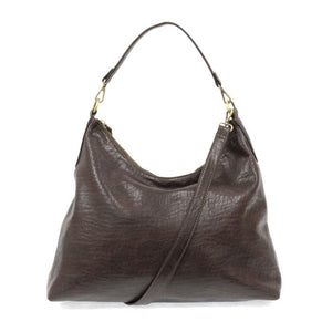 This oversized, slouchy, cool hobo bag is made of tumbled buffalo grain espresso bean colored vegan leather, which gives it that casual boho chic look! With two removable shoulder straps included, you can wear it as a short-shoulder bag or a crossbody bag.  Dimensions: 13.5 in. H x 16 in. W x 3.5 in. D