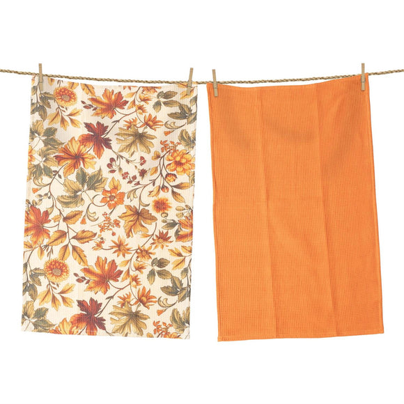 Two towels hanging on a line, one with floral pattern and the other solid orange.