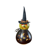 Fiona is our enchanting witch that is hand-crafted from hard shell gourds. She is hand-dyed green and black in color. expert crafters hand-cut her fun winking face, and her star and moon cutout. She has a handmade black felt witch hat and a handmade black clay nose. Fiona sits on a removable cork base to allow the design to be lit with a battery-operated tea light, or an orange col.

Warning: Gourds are flammable. Do not use candles in them or place them near open flames.

Made in the United States

Dimensi