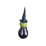 You KNOW you have to have this darling witch this year! Our Fiona witch is hand-crafted from hard shell gourds. She is hand-dyed green and black. expert crafters hand-cut her face and the star and moon design on her belly. She comes with an electric light that shines a warm subtle glow through her crafted design. Her black witch hat is handmade and adorned with fall-colored berries. She has a handmade black clay nose, and black raffia is tied around her neck.

Warning: Gourds are flammable. Do not use candl