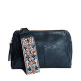 Retro styling crafted in antiqued vegan leather gives this dark indigo clutch a vintage vibe. The removable woven wrist strap is the finishing touch on this stylish bag so you can wear it as a wristlet, a clutch, or a crossbody with the included removable shoulder strap!





6.75"H x 9.75"W x 2.25"D

Removable and adjustable crossbody strap 22"-26"

Removable long wristlet strap 7.5" long

Zippered top closure

Interior zippered pocket

Exterior back zipper pocket

Brass plated hardware

100% vegan leather