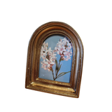 This gold, distressed arched frame is perfect for displaying a cherished photo, or you can keep the lovely bird print that comes inside! It will complement your home decor beautifully. Additionally, it features a hook on the back for easy hanging on the wall.

Frame is approximately 4.25" H x 3.5" W x 1" D

Fits a photo 2.5" W x 3.5" H

Wood, Glass