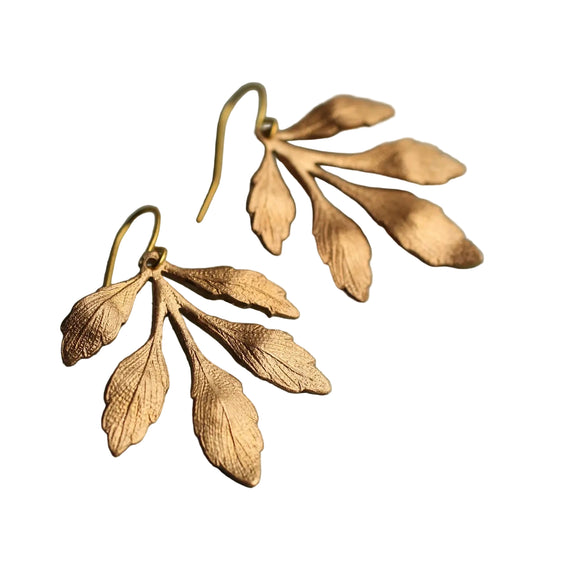 These great chandelier style leaf earrings feature a stylised and beautifully detailed leaf design in a golden brass. The leaves have subtle texture on the surface to give an interesting, more organic finish.

The earrings measure just about two inches in length