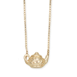 Pour a little charm into your look with this gold teapot necklace! Gold box chain features floral detailed tiny teapot pull through pendant. Whimsical, vintage inspired and perfectly dainty, this necklace adds a playful touch to any outfit. Ideal for tea lovers, cottage core fans, this gold teapot necklace is delicate and full of everyday elegance.

Made in China

Measures (approx.): 16-18" long, 5/8 x 3/8" pendant

Materials: Gold Tone Metal

Closure: Lobster Clasp