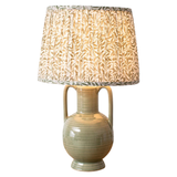 This stunning sage green jug lamp will add color to any space, featuring a pleated white shade with intricate sage green leaves. It's the perfect blend of elegance and charm!

Overall 19.25" H, Shade 8.75" H x 12" Dia; Base 13" H x 5.25" W

Ceramic, Fabric, Iron