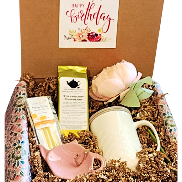 If she LOVES tea, send her a tea box today! Our Birthday Tea Box has our popular Basket Weave Tea Infuser Mug with a grey silicone lid that she'll be able to brew our  Strawberry Raspberry (black) tea in. We've also included a Pink Teapot Bag/Spoon Holder and some Honey Sticks.  She'll love the Pretty Silk Peony Stem to put in her favorite vase. All of this is packed in crinkle and wrapped up in a pink, green, blue and white floral patterned tissue and tied in a bow.  If you'd like us to