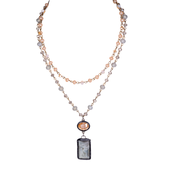 We are loving this beautiful multi-strand necklace with adjustable lobster claw closure! Each strand is a beaded chain link. The longer strand has a rectangle stone pendant and crystal. 

Length: 12
