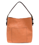 Timeless and modern, our best-selling classic hobo is made in rich vegan leather in a beautiful coral peach color, accented with a coffee brown strap.&nbsp; This roomy bag, accented with a large front pocket and a snap-in removable brown crossbody, has plenty of room to carry your needs in style.


MAIN BAG

12" h x 14" w x 6" d

Adjustable strap 6"-11"

Magnetic snap top closure

Exterior open pocket

Two snaps to attach insert to act as a lining

Brass plated hardware

100% Vegan leather (polyurethane)

R