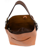 Timeless and modern, our best-selling classic hobo is made in rich vegan leather in a beautiful coral peach color, accented with a coffee brown strap.&nbsp; This roomy bag, accented with a large front pocket and a snap-in removable brown crossbody, has plenty of room to carry your needs in style.


MAIN BAG

12" h x 14" w x 6" d

Adjustable strap 6"-11"

Magnetic snap top closure

Exterior open pocket

Two snaps to attach insert to act as a lining

Brass plated hardware

100% Vegan leather (polyurethane)

R