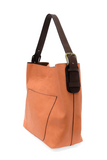 Timeless and modern, our best-selling classic hobo is made in rich vegan leather in a beautiful coral peach color, accented with a coffee brown strap.&nbsp; This roomy bag, accented with a large front pocket and a snap-in removable brown crossbody, has plenty of room to carry your needs in style.


MAIN BAG

12" h x 14" w x 6" d

Adjustable strap 6"-11"

Magnetic snap top closure

Exterior open pocket

Two snaps to attach insert to act as a lining

Brass plated hardware

100% Vegan leather (polyurethane)

R