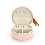 A beautiful gift for yourself or a friend, this traveling jewelry case is pink with a brown strap closure. Inside there is room for your jewelry for a short weekend or a couple of weeks!

Foam, metal, paper, polyester fiber, polyurethane

2.5" h x 4.5" w x 4.5" d