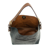 Equally timeless and modern, our best-selling classic hobo comes in rich vegan leather in a gorgeous, vivid deep teal, with a brown strap.&nbsp; This roomy bag, accented with a large front pocket and a snap-in removable brown crossbody, has plenty of room to carry your needs in style.


MAIN BAG

12" h x 14" w x 6" d

Adjustable strap 6"-11"

Magnetic snap top closure

Exterior open pocket

Two snaps to attach insert to act as a lining

Brass-plated hardware

100% Vegan leather (polyurethane)

REMOVABLE INS