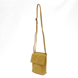 With a slim, streamlined look, this vegan leather crossbody in a beautiful laguna yellow color features a top flap with magnetic snap closure and an adjustable shoulder strap so you can carry it as a crossbody or a shoulder bag. With two convenient slip pockets, one under the flap and one on the back you can keep your phone and keys in easy reach.


Dimensions: 9.5 in. H x 8 in. W x 2.75 in. D
Magnetic snap closure
Adjustable shoulder strap: 14 in. - 27.5 in. drop
Brass plated hardware
100% Vegan leather (p