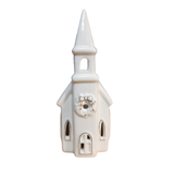 This sweet ceramic church is decorated for the holiday with a wreath above the center window. That window, the two windows on either side, the steeple opening and then the two large windows on each side of the church light up with a LED bulb making it glow for the winter season! There is an on and off switch to turn the light on. There is no timer switch on this holiday church.

approximately 2.75" W x 6.75" H

Ceramic