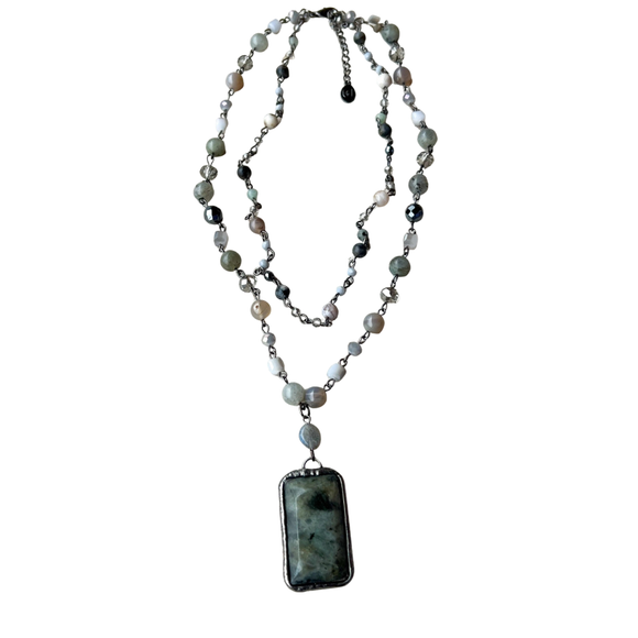 We are loving this beautiful multi-strand necklace with adjustable lobster claw closure! Each strand is a beaded chain link. The longer strand has a rectangle stone pendant and crystal. 

Length: 18.5