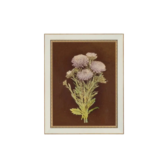 A pretty bunch of lilac colored dahlias with a brown background is printed on premium canvas fabric for a lasting, textured finish. The 7 x 9 measurement reflects the outside dimensions of the frame. The handcrafted ornate frame adds classic charm. It comes with a paper backing and hanging hardware for easy installation. The glass free design keeps the artwork lightweight and true to its original texture.

Made in the USA: Proudly crafted with quality and care. 

Care Instructions: Keep canvas dry to m
