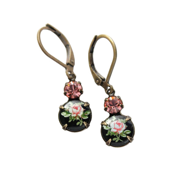 These are beautiful vintage style drop earrings in shades of pink and black! Set in antique brass prong settings are two vintage glass and crystal pieces including a floral vintage limoge, round glass focal in black and pink and a sparkling coral pink Swarovski crystal.

These are lightweight and nickel free. The glass jewel drop in the setting measures approximately just over 1/2