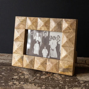 This beautiful 4x6 picture frame complements so many styles of decor with its neutral and crafted aesthetic. The natural mango wood squares are carved into geometric shapes and pieced together by hand to create a unique and textural frame border. The natural variation in wood grain and tone adds to the rustic boho look. -Hang on a wall or display on a desk, mantel, or coffee table.&nbsp;