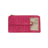 This slim and sleek wallet has nine credit card pockets, each with a snap tab for security and brass-plated hardware. It also has an ID window, zippered change pocket, and zippered billfold pocket in distressed beautiful magenta vegan leather.


DIMENSIONS: 3.75 IN. H X 7.25 IN. W X .25 IN. D&nbsp;


100% Vegan leather (polyurethane)