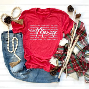 We are loving our new holiday t-shirt in a festive red color!&nbsp; The word "Merry" is written in white cursive on top of words of the season like: cozy blankets, warm fires, hot cocoa, stockings, holly, family, Santa Clause and more!