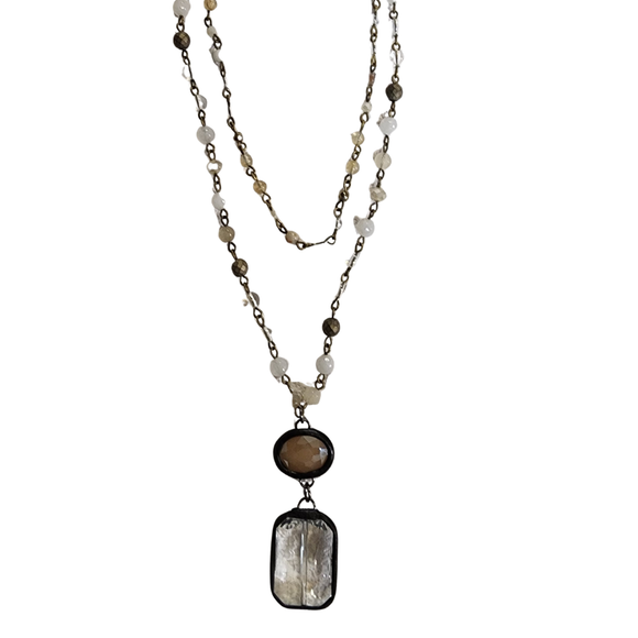 We are loving this beautiful multi-strand necklace with adjustable lobster claw closure! Each strand is a beaded chain link. The longer strand has a rectangle stone pendant and crystal. 

Length: 8.5