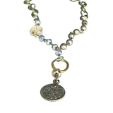 Short, lariat style necklace with intricate coin pendant. The strand is a chain link with gorgeous beading throughout.

11" long, 1" coin pendant