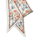 This cream scarf has a brown border and orange, gold, tan and blue daisies printed all over it! We love tying these around our purses to add a fun pop of color! Of course, they look fabulous around your neck as well!

Approximately 57" L x 5.25" W

100% Polyester