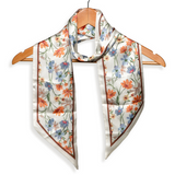 This cream scarf has a brown border and orange, gold, tan and blue daisies printed all over it! We love tying these around our purses to add a fun pop of color! Of course, they look fabulous around your neck as well!

Approximately 57" L x 5.25" W

100% Polyester