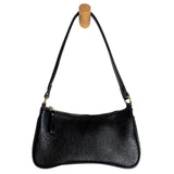 Meet Nicolette, our sleek, curvy black colored crossbody pochette with a minimalist style. Featuring soft sculptural curves in tumbled vegan leather, this bag is closed with a brass zipper that encloses 3 interior compartments to keep your cards, cash, keys and phone stowed neatly. The gleaming brass rings open to swap out the two included shoulder straps. A short strap for dressier looks and a longer adjustable crossbody strap when you want to go hands free. The Nicolette will add a stylish pop to your loo