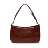 The sleek pecan Erin Hobo will compliment your look for the office or your next night out. Fashioned in glossy croc embossed vegan leather, this sophisticated bag closes with a brass zipper to keep your belongings secure and is accented with burnished brass rings that open to allow you to change the shoulder straps. Two shoulder straps are included with this stylish Hobo, a short strap to carry close to the body or a long strap to carry as a shoulder bag or as a crossbody. Both straps are adjustable and rem