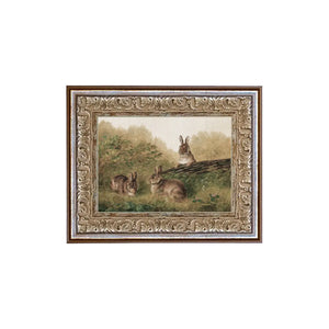 We are obsessed with this little works of art! Three brown bunnies are playing in the woods around a log. You'll find lots of places to put this mini artwork!&nbsp;Printed on premium canvas fabric for a lasting, textured finish and has a handcrafted ornate frame that adds a classic charm.&nbsp; Comes with a paper backing and hanging hardware for easy installation.

Made in the USA: Proudly crafted with quality and care.&nbsp;

Care Instructions: Keep canvas dry to maintain its quality. If smudged or dirty, 