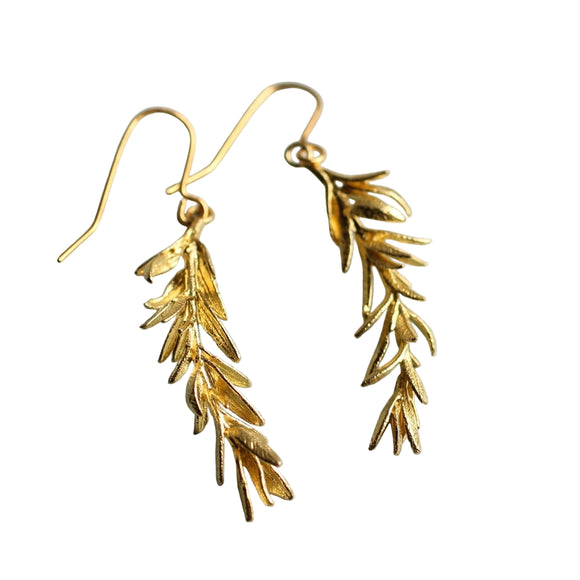 These rosemary leaf earrings are made from solid brass with some amazing detail. They feature a detailed sprig of tiny leaves, in a rich golden brass tone. 

The earrings measure just less than two inches long and are designed to hang around jaw level. The ear wires are made from solid brass.