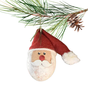 Santa Claus is natural and white. He wears an adorable red sock hat and has a hook to attach him to a tree. Because this design is crafted using a natural gourd, each piece is ever so slightly different, making for a unique artisan piece with natural variance in color and size.&nbsp;

Approximately 2" in diameter and 3" tall.

Warning: Gourds are flammable. Do not use candles in them or place them near open flames.