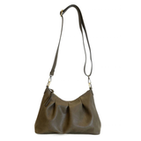 The Sasha Hobo is made of gently tumbled vegan leather in olive, accented with soft pleats and closed with a brass zipper. This crossbody is so versatile with 2 different interchangeable shoulder straps included, just open the gleaming brass rings to change from a short shoulder strap to a longer adjustable crossbody strap.
Product Details
Dimensions: 9.5 in. H x 12.5 in. W x 3.5 in. D
Top zip closure
Brass plated hardware
Logo zipper pulls
Opening brass rings to change between the included shoulder straps
