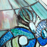 Close-up of a stained glass with blue and green colors.