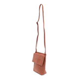 With a slim, streamlined look, this vegan leather crossbody in a beautiful clay pink color features a top flap with magnetic snap closure and an adjustable shoulder strap so you can carry it as a crossbody or a shoulder bag. With two convenient slip pockets, one under the flap and one on the back you can keep your phone and keys in easy reach.


Dimensions: 9.5 in. H x 8 in. W x 2.75 in. D
Magnetic snap closure
Adjustable shoulder strap: 14 in. - 27.5 in. drop
Brass plated hardware
100% Vegan leather (polyu