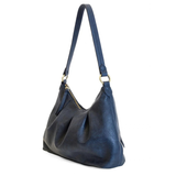 The Sasha Hobo is made of gently tumbled vegan leather in navy, accented with soft pleats and closed with a brass zipper. This crossbody is so versatile with 2 different interchangeable shoulder straps included, just open the gleaming brass rings to change from a short shoulder strap to a longer adjustable crossbody strap.
Product Details
Dimensions: 9.5 in. H x 12.5 in. W x 3.5 in. D
Top zip closure
Brass plated hardware
Logo zipper pulls
Opening brass rings to change between the included shoulder straps
1