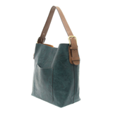 Equally timeless and modern, our best-selling classic hobo comes in rich vegan leather in a gorgeous, vivid deep teal, with a brown strap.&nbsp; This roomy bag, accented with a large front pocket and a snap-in removable brown crossbody, has plenty of room to carry your needs in style.


MAIN BAG

12" h x 14" w x 6" d

Adjustable strap 6"-11"

Magnetic snap top closure

Exterior open pocket

Two snaps to attach insert to act as a lining

Brass-plated hardware

100% Vegan leather (polyurethane)

REMOVABLE INS