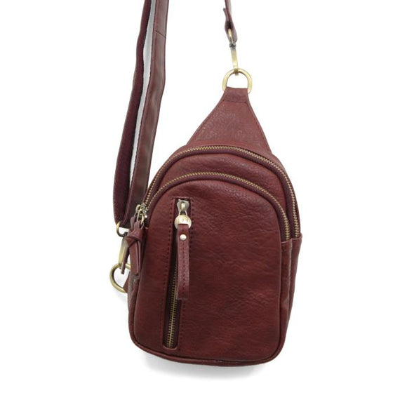 Blending uptown chic with downtown cool, the Skyler sling bag is made in rich dark cherry vegan leather! A convertible strap lends versatility, while a front zip pocket offers practical storage for your necessities. It is the perfect companion for a night out on the town or a fun day trip!


8