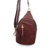 Blending uptown chic with downtown cool, the Skyler sling bag is made in rich dark cherry vegan leather! A convertible strap lends versatility, while a front zip pocket offers practical storage for your necessities. It is the perfect companion for a night out on the town or a fun day trip!


8" h x 5.5" w&nbsp; x 2.25" d
Removable and adjustable convertible strap 20"-30" drop
Zippered top closure
Exterior front zip pocket
2 exterior zip compartments
4 interior credit card pockets
Brass plated hardware
100% 