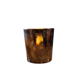 This beautiful small marbled bronze candle holder has etched leaves scattered all around it. A beautiful piece to stick in with your fall decor, it easily fits a small candle or a votive and will create a gorgeous glow in your home!

Candle not included

Glass

Approximately 3" H x 2.5" Dia&nbsp;
