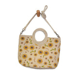 Sunflowers just make us smile! This soft Jute tote is strewn with hand painted sunflowers to bring a happy, sunny vibe to all your warm weather looks. The cute circular handles and detachable shoulder strap adds versatility so that this bag will be the perfect companion whether you're wearing your favorite summer dress or white jeans!

Product Details
Dimensions: 11 in. H x 15 in. W x 5 in. D
Open Top Circular Handles: 4 in. drop
Removable Shoulder strap: 21 in. drop
Brass plated hardware
100% Natural Jute 