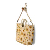 Sunflowers just make us smile! This soft Jute tote is strewn with hand painted sunflowers to bring a happy, sunny vibe to all your warm weather looks. The cute circular handles and detachable shoulder strap adds versatility so that this bag will be the perfect companion whether you're wearing your favorite summer dress or white jeans!

Product Details
Dimensions: 11 in. H x 15 in. W x 5 in. D
Open Top Circular Handles: 4 in. drop
Removable Shoulder strap: 21 in. drop
Brass plated hardware
100% Natural Jute 