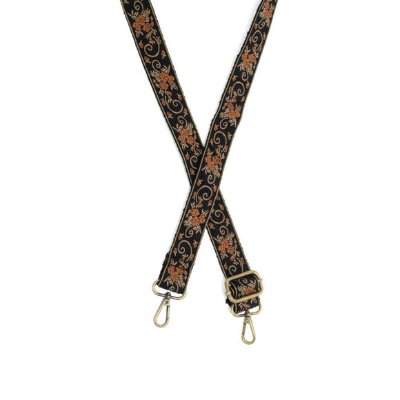 Make your purse or crossbody HAPPY with this black guitar strap with tan scrolls and pumpkin colored florals going down it! The back of the strap is black.

1.2