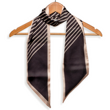 Make a statement with this tan and black striped scarf!

Approximately 57" L x 5.25" W

100% Polyester