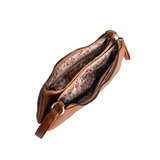 Meet Nicolette, our sleek, curvy cognac colored crossbody pochette with a minimalist style. Featuring soft sculptural curves in tumbled vegan leather, this bag is closed with a brass zipper that encloses 3 interior compartments to keep your cards, cash, keys and phone stowed neatly. The gleaming brass rings open to swap out the two included shoulder straps. A short strap for dressier looks and a longer adjustable crossbody strap when you want to go hands free. Available in an array of beautiful colors, the 