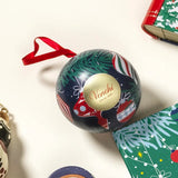 Venchi's Ball Metal Chocolate Blue Tin Christmas Ornament adds festive shimmer to the holiday season. Shaped like a Christmas tree ornament, this tin features whimsical Christmas illustrations and holds a selection of milk and dark cream and crunchy chocolates inside. Each reusable tin offers a refined presentation that doubles as keepsake décor long after the chocolate inside is gone, with festive artwork designed to display on the tree or wherever holiday decorations gather

Gluten-free chocolate made in 