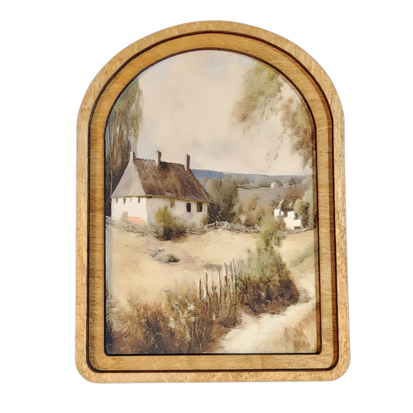 With trees framing this artwork on each side, it sets the scene! There is a patch along the right side that goes along a fenced in field that leads to a big white cottage in the back of the frame. Printed onto canvas using high quality Canon pigment inks. The canvas is then mounted onto a wood backer. This piece has a double layered wood frame stained in a neutral Early American tone. This piece can be hung on a wall using an adhesive strip or it can sit on a shelf.

8